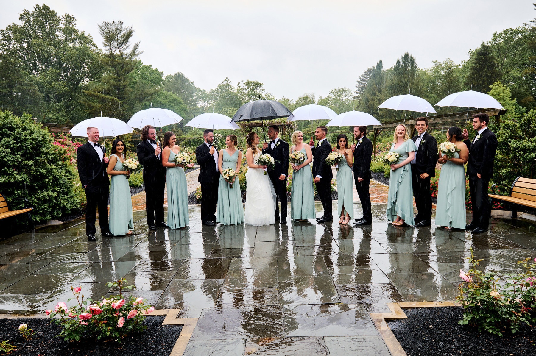 bridal party photo in the rain colonial park rose garden