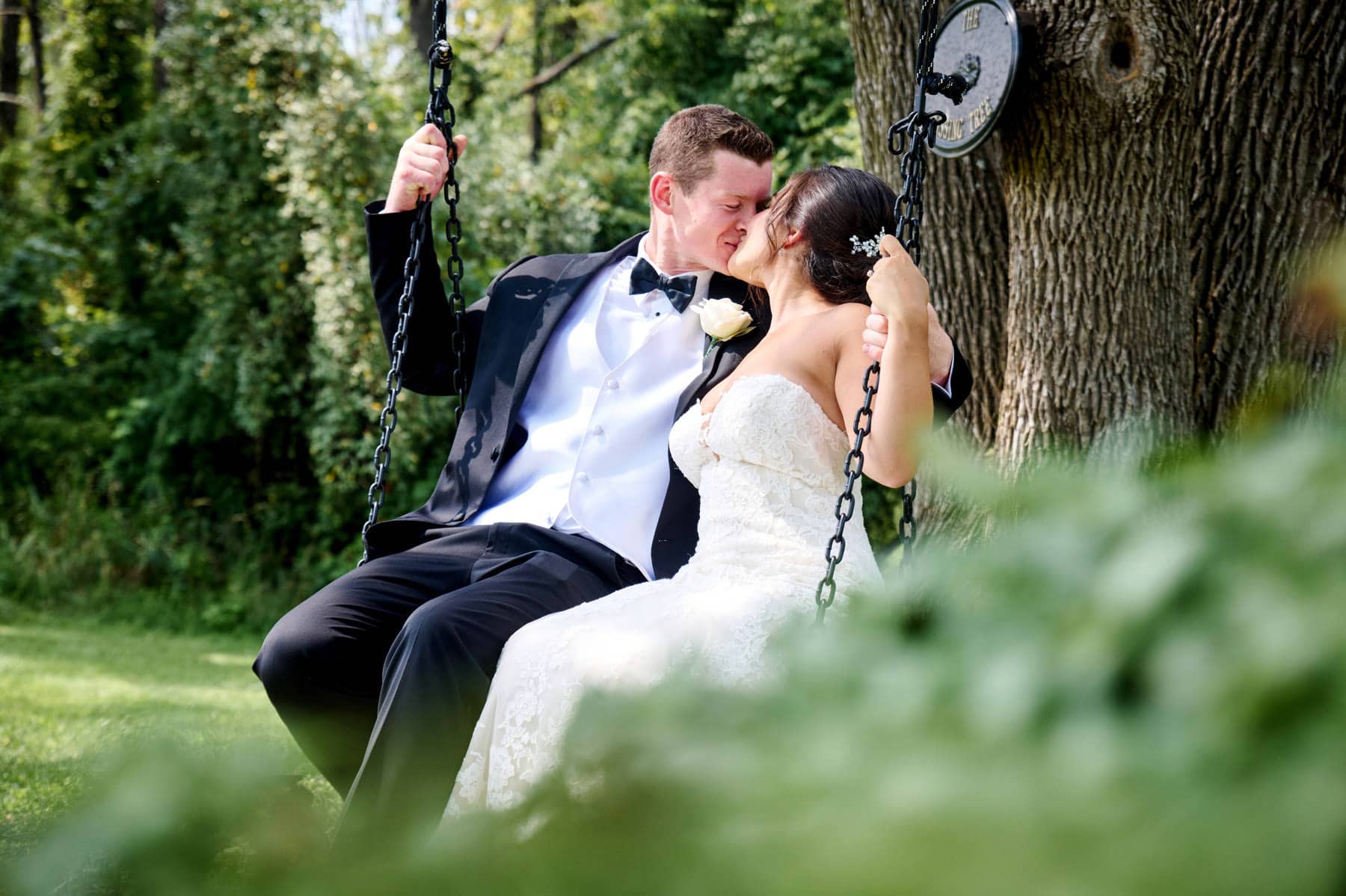 bride and groom on the swing at The Farmhouse