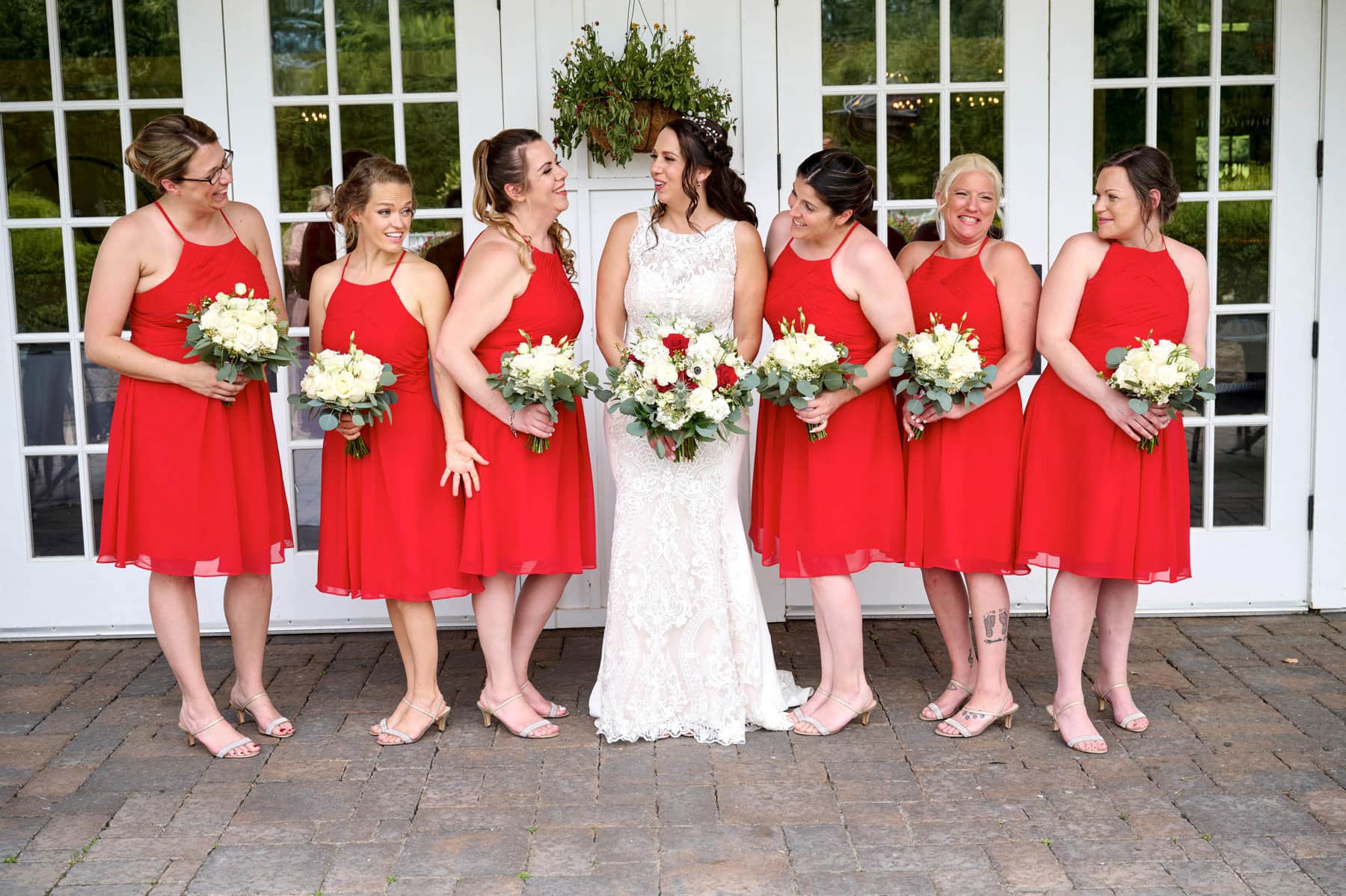 bride and her bridesmaids on the back patio at The Farmhouse