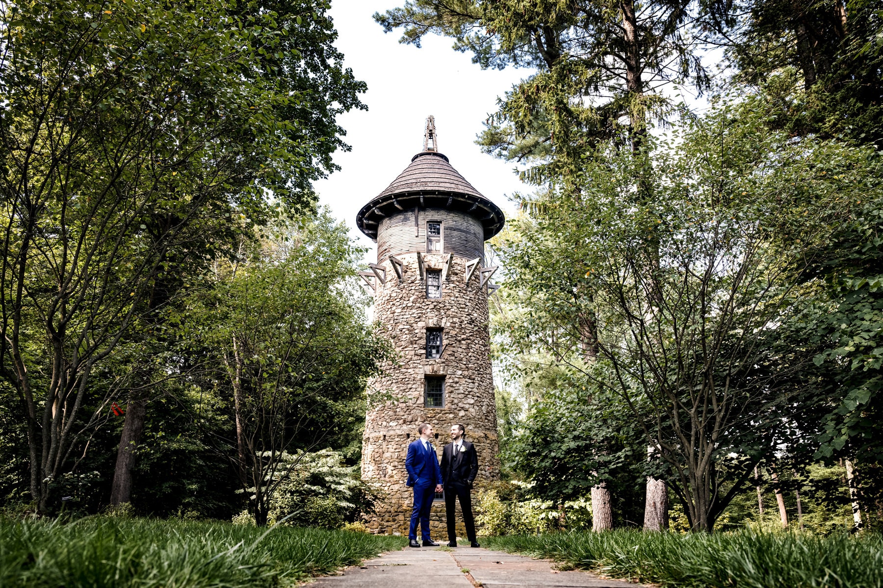 2 grooms by the watch tower at Cross Estate Gardens