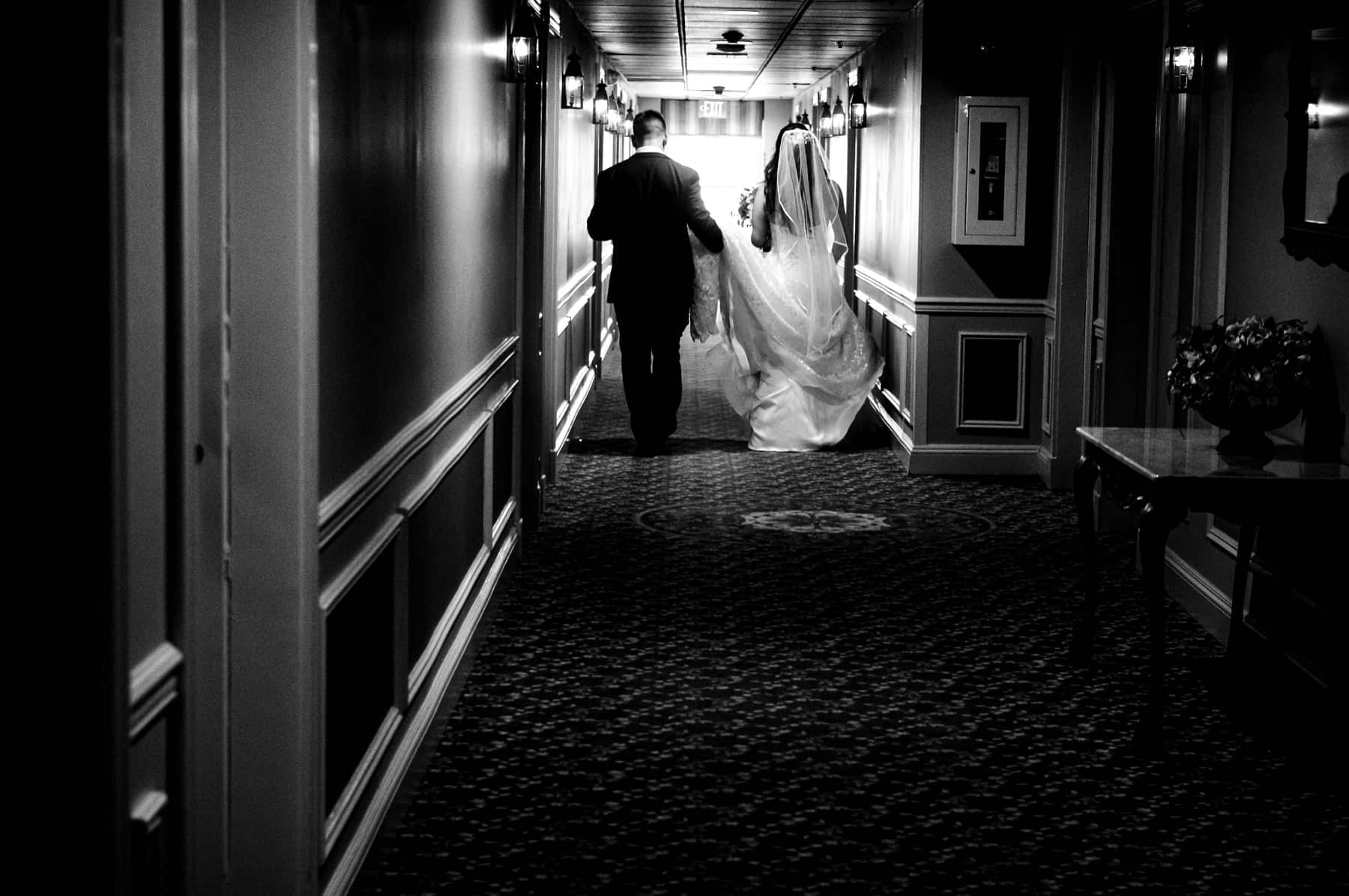 bride and groom walk down the hallway at The Olde Mill Inn