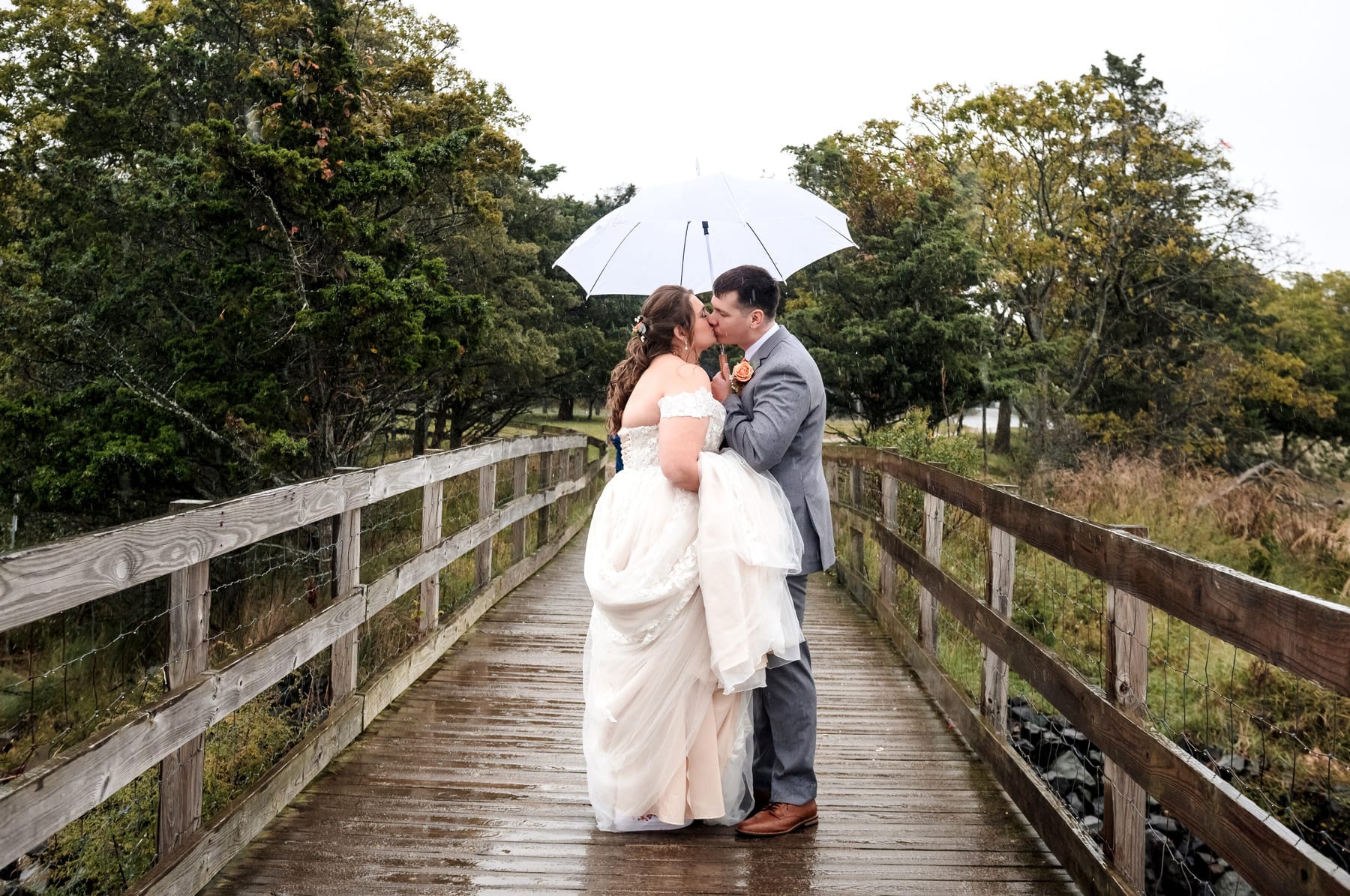 bride and groom in the rain on their wedding day