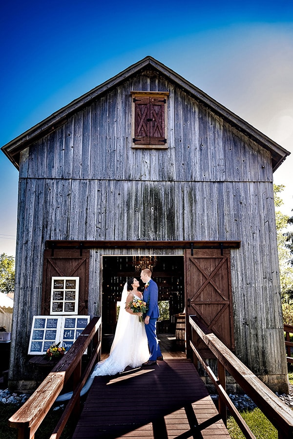 five birds farm wedding bride and groom in front of the barn at five birds farm